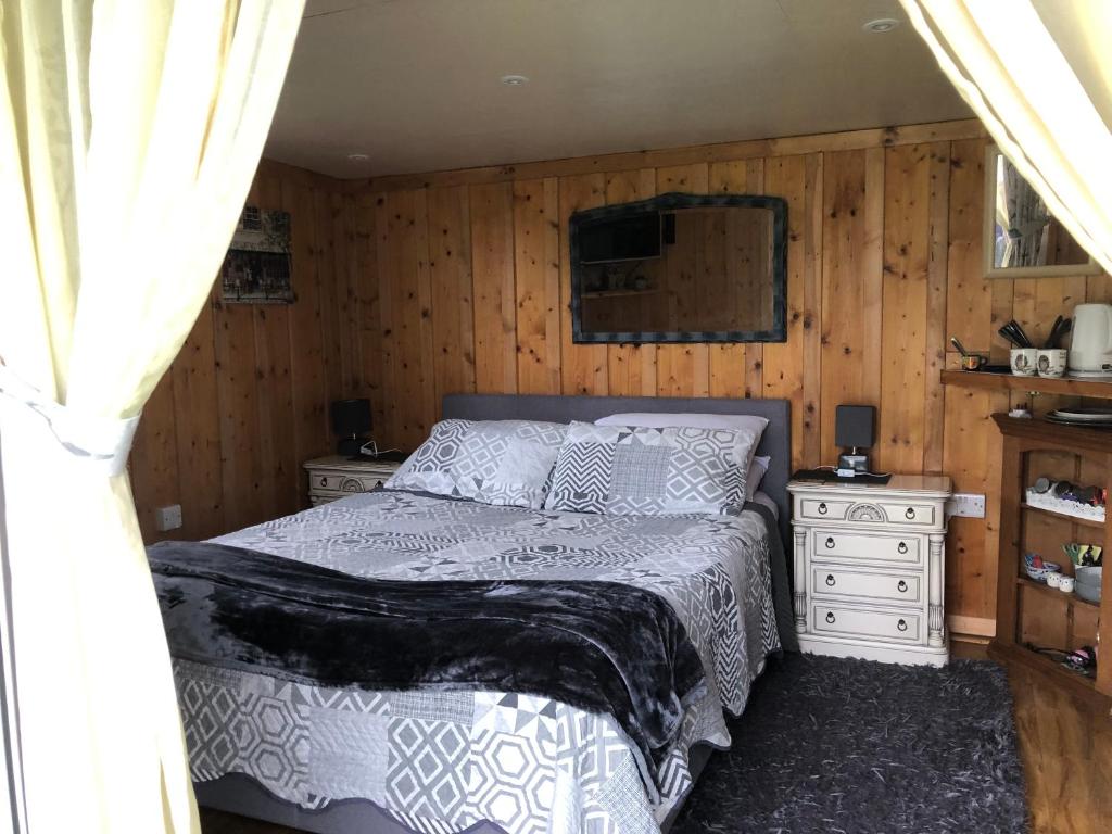 a bedroom with a bed and two night stands at Owly 'Ouse in Barnstaple