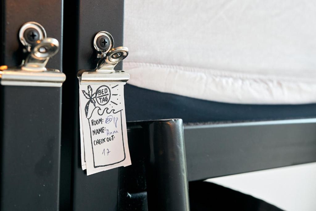 a tag hanging from a door of a bed at Jungle Jaffa Hostel Age 18 to 45 in Tel Aviv
