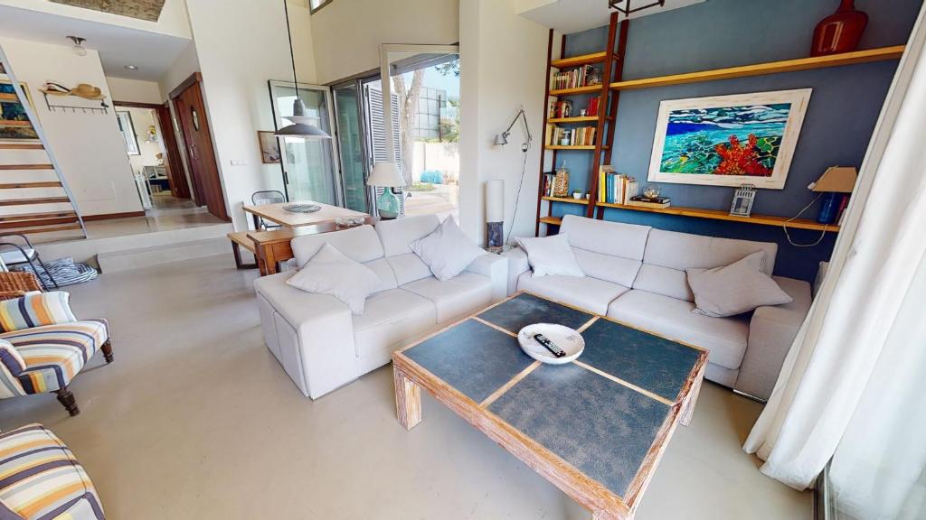 a living room with a couch and a table at Villa Buenos - A Murcia Holiday Rentals Property in Santiago de la Ribera