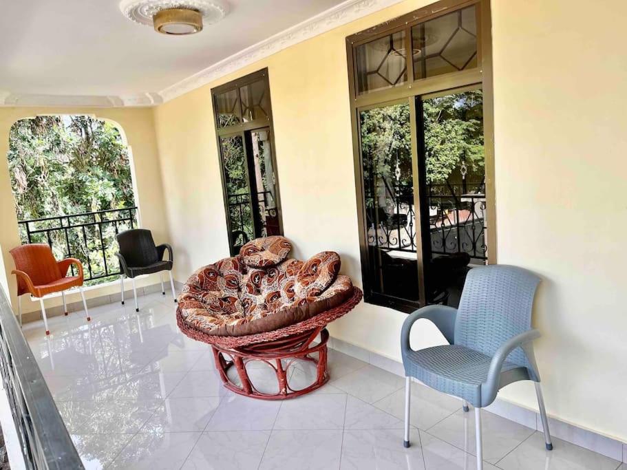 a living room with a couch and two chairs at Burka Serene Home in Arusha