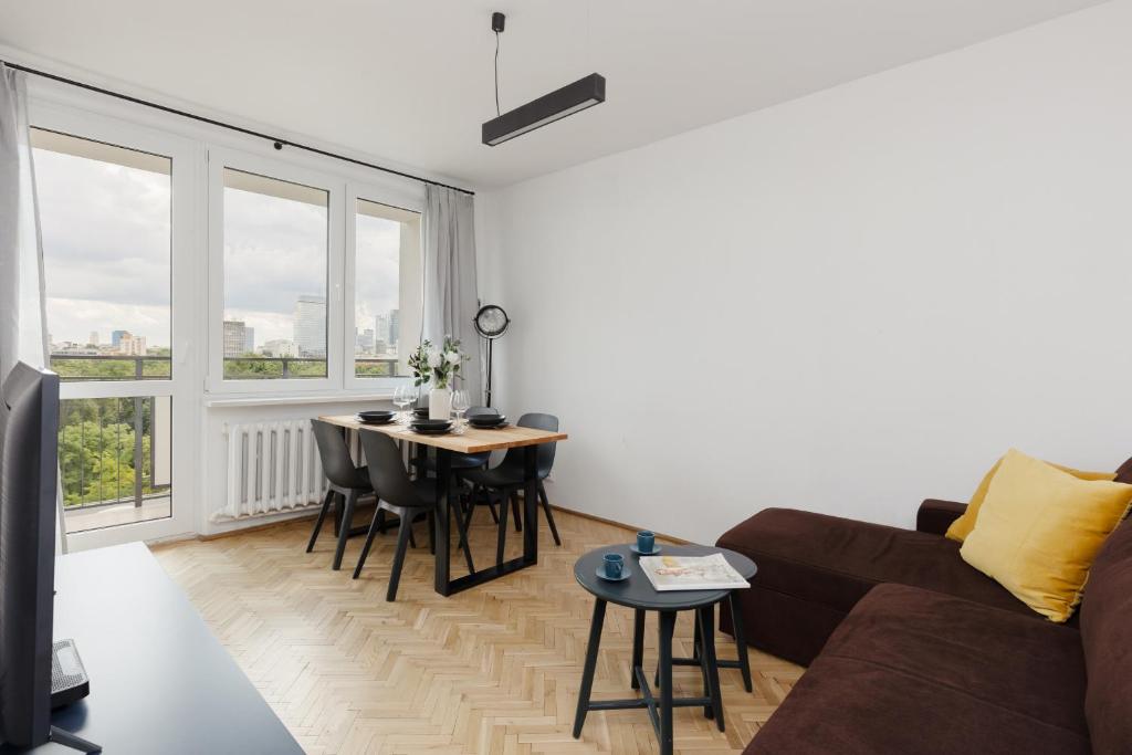 a living room with a couch and a table at Family Apartment near Old Town by Renters in Warsaw