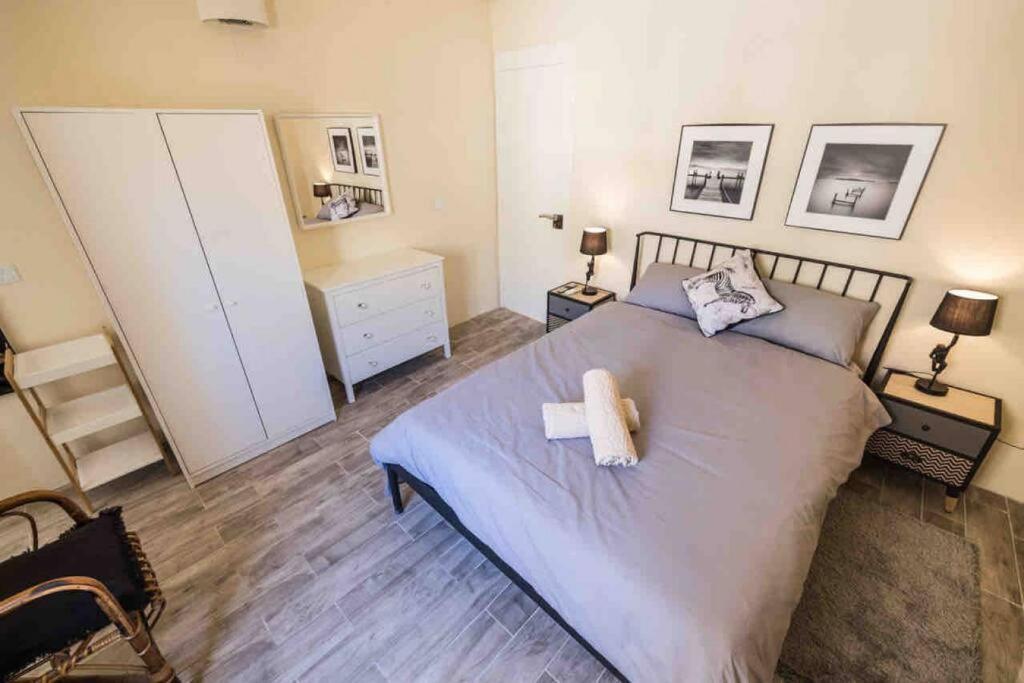 a bedroom with a bed with a white towel on it at Kalkara 4 in Cospicua