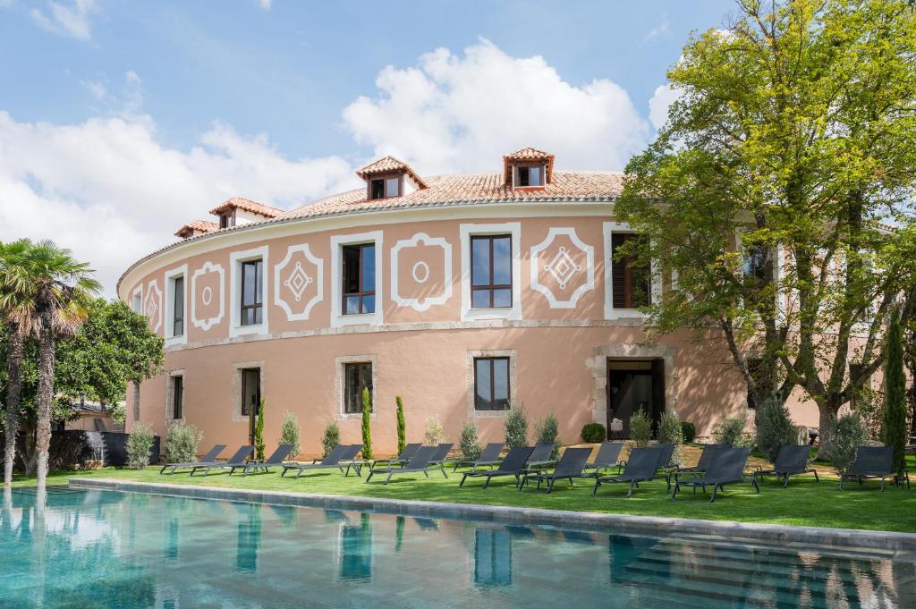 a house with a pool in front of it at Castilla Termal Brihuega in Brihuega