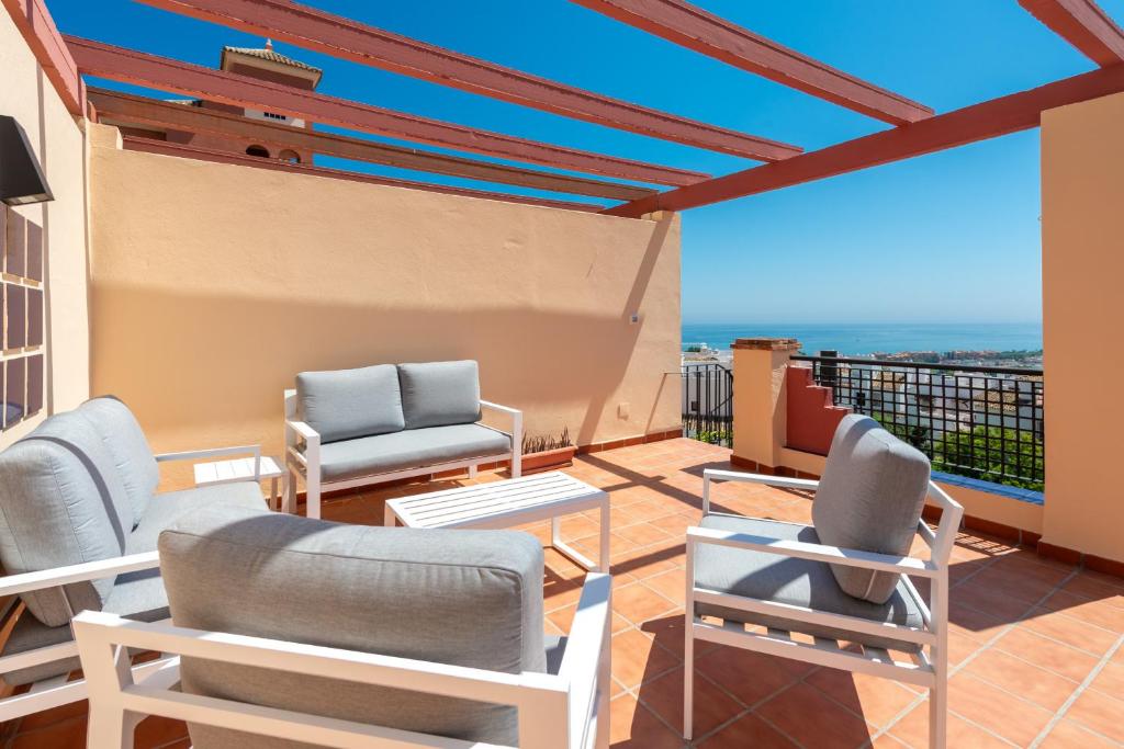 a balcony with chairs and a view of the ocean at Duquesa Regent 2435 Wonderful seaviews duplex in Manilva