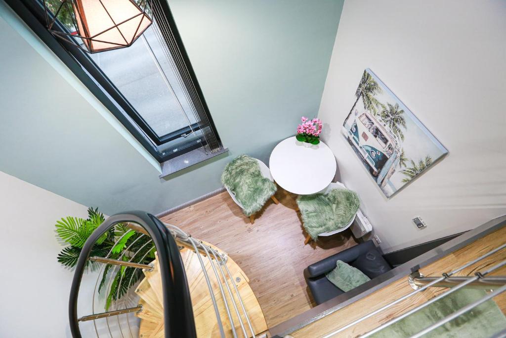 an overhead view of a staircase with a table and chairs at A105 Stylish City loft in Coventry