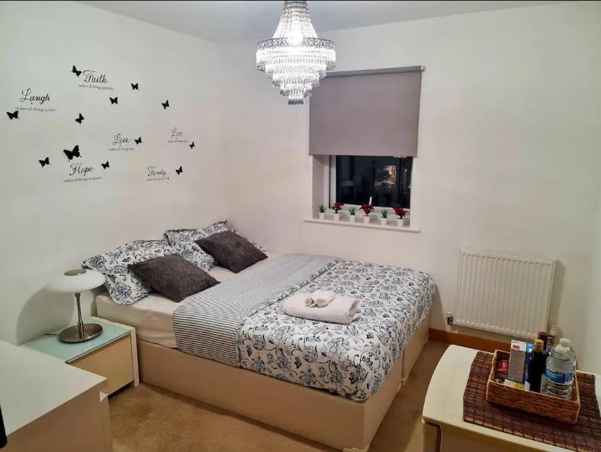 una camera da letto con un letto con farfalle nere sul muro di Entire Lovely 2 Bedroom Apartment a Southend-on-Sea