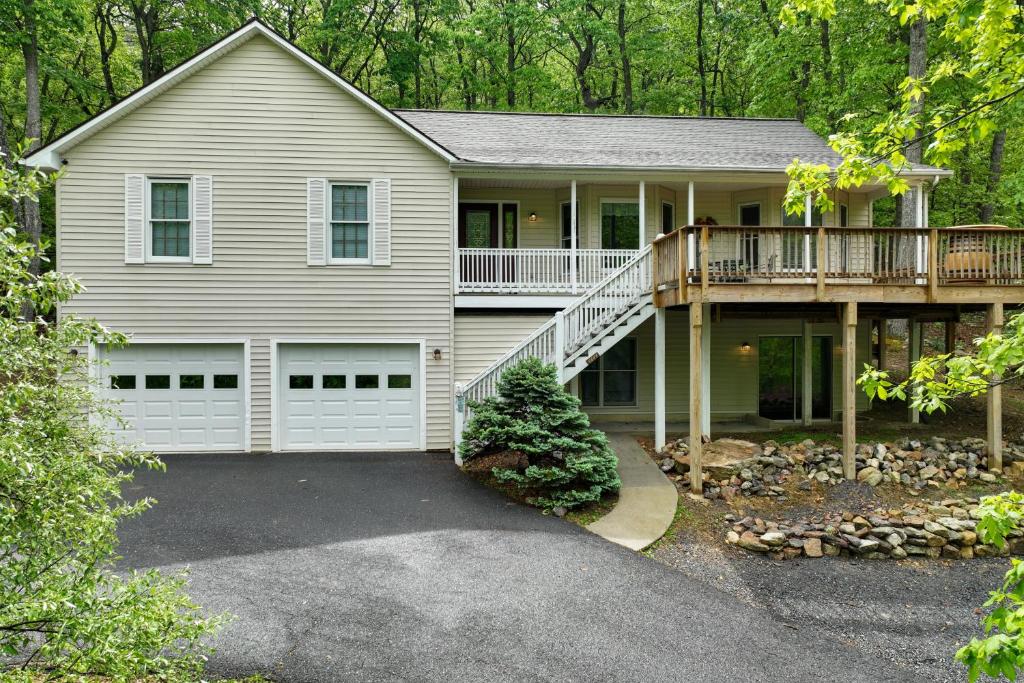 a large house with a balcony and a deck at Big Home Game Room, Hot Tub and 17-Seat Theater in Massanutten