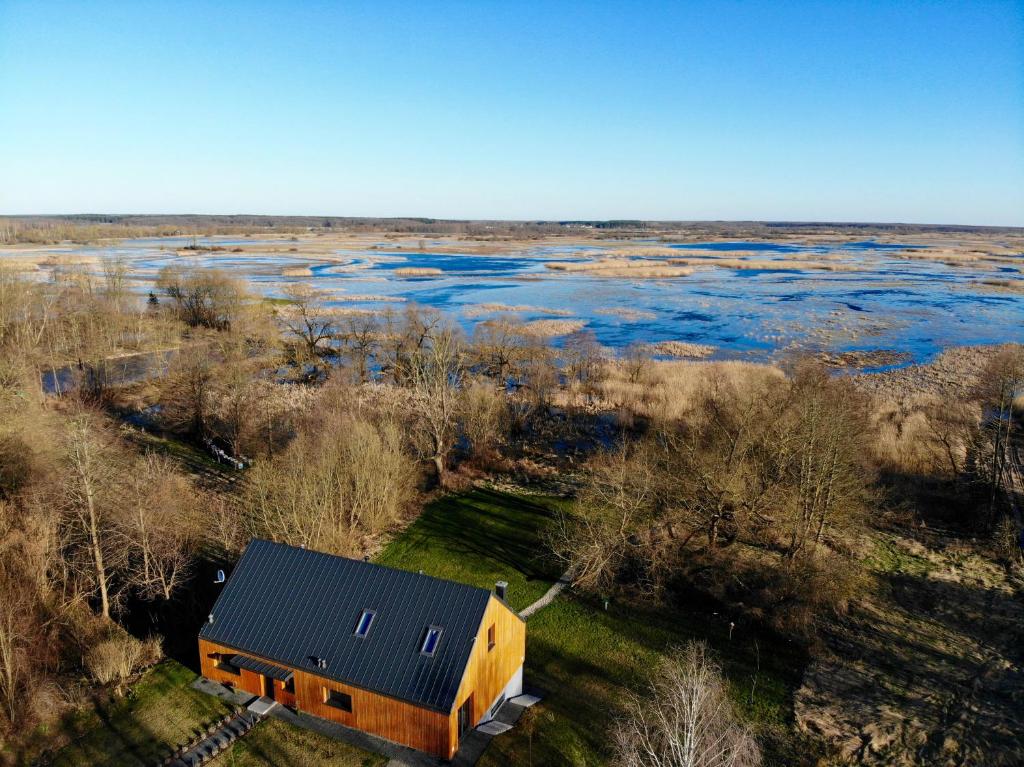 an aerial view of a house next to a river at Stodoła nad Biebrzą in Goniadz