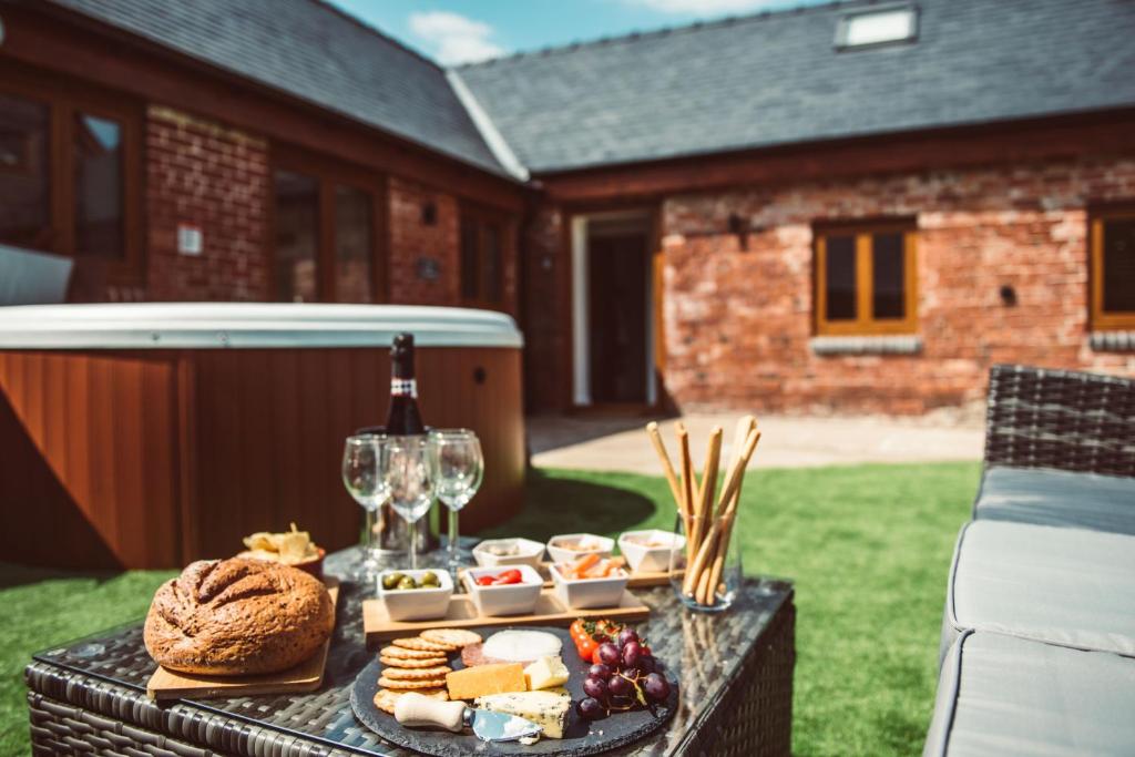 a table with a tray of food and glasses of wine at The Granary in Montgomery