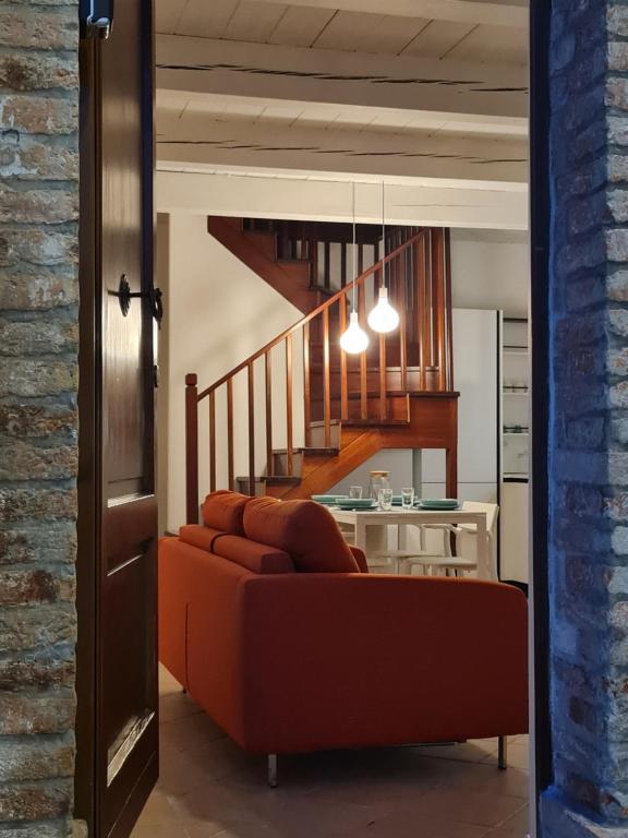 a living room with a couch and a staircase at La serva padrona in Iesi