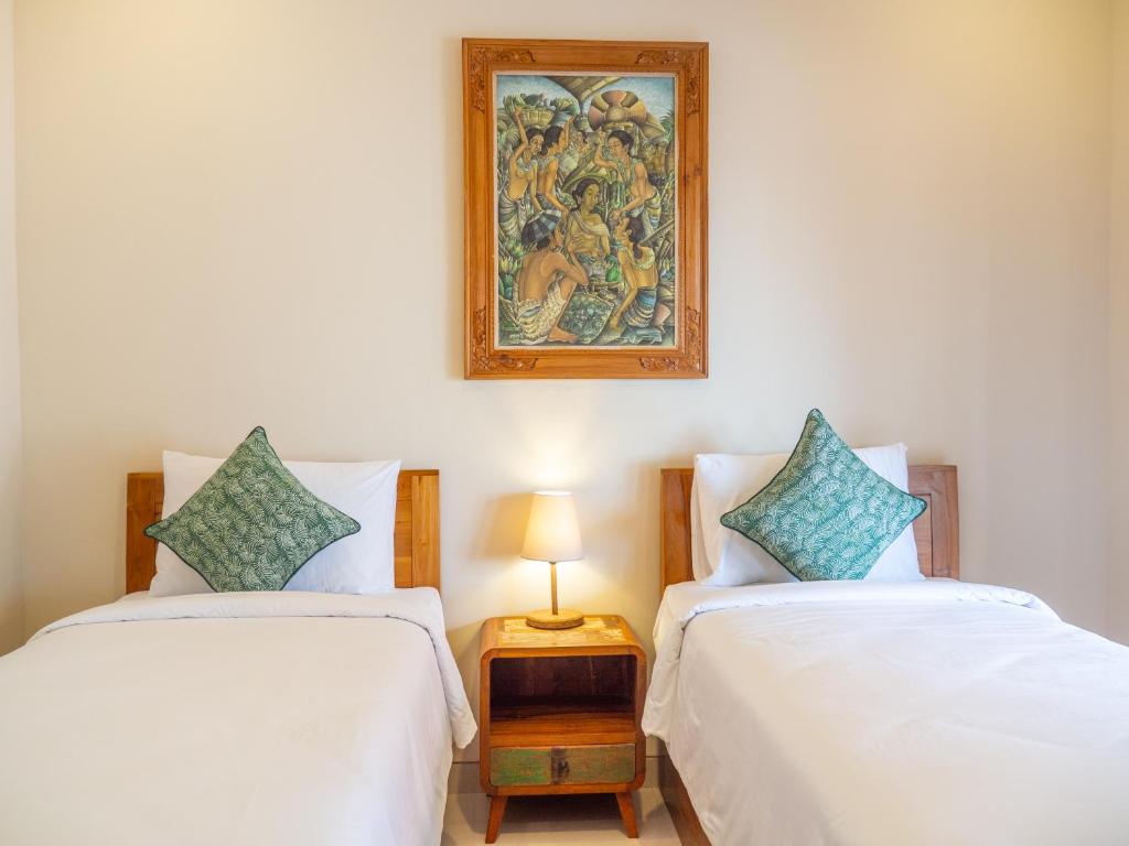 Postel nebo postele na pokoji v ubytování Arumasta Ubud