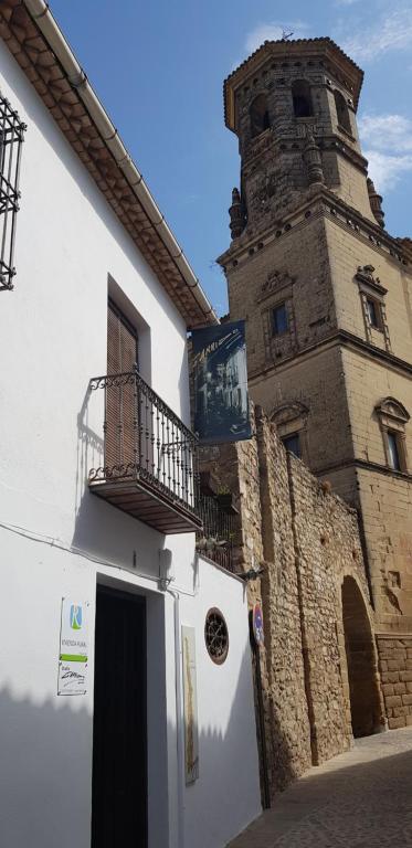a building with a clock tower on the side of it at La Casa del Pintor - Estudio de Arte en Baeza in Baeza
