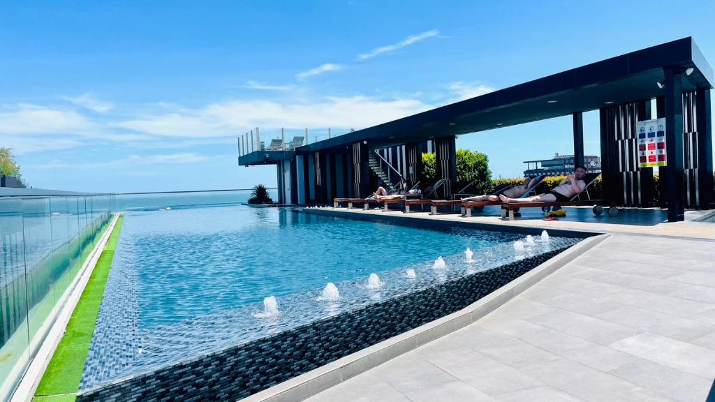 a swimming pool with swans in the water on a building at The base Central Pattaya by Numam 38 in Pattaya Central