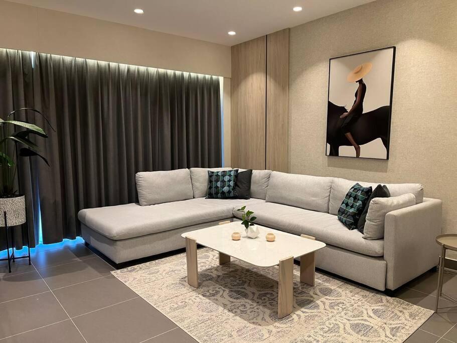 a living room with a couch and a coffee table at DAMAC Luxury new 1 bedroom apartment in Amman