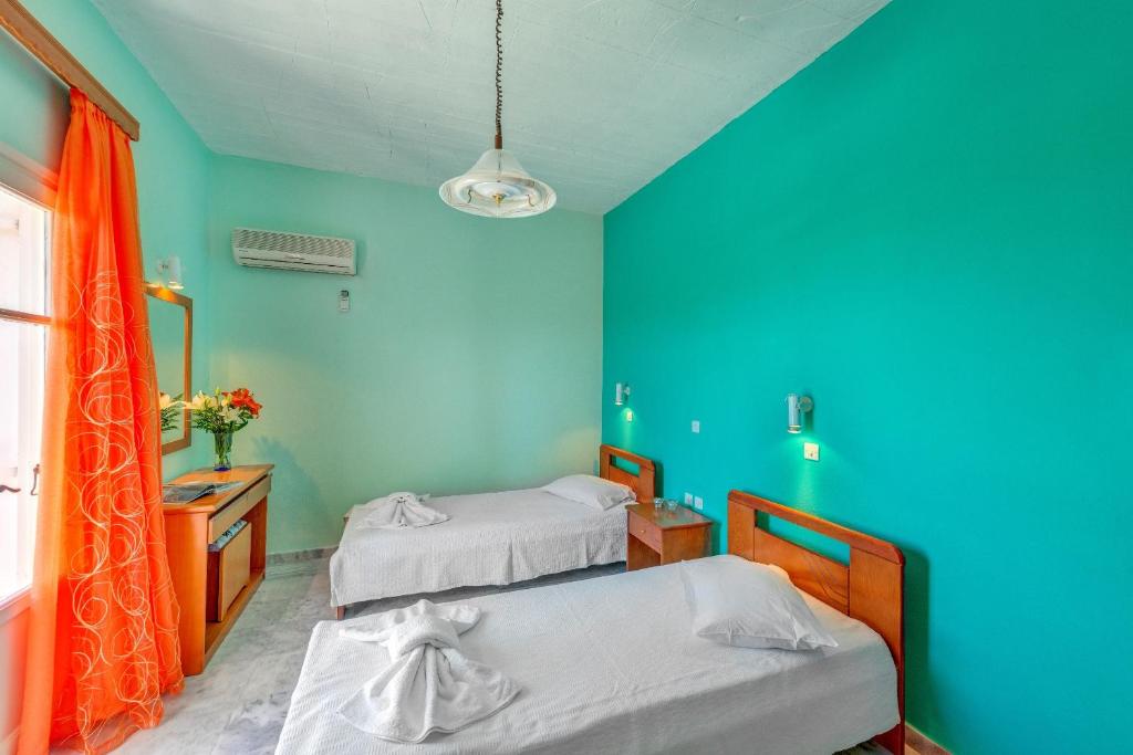 Postel nebo postele na pokoji v ubytování Hotel Smaragdi Apartments