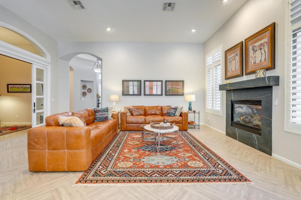a living room with a couch and a fireplace at Phoenix Vacation Rental Near Golf and Shopping in Phoenix