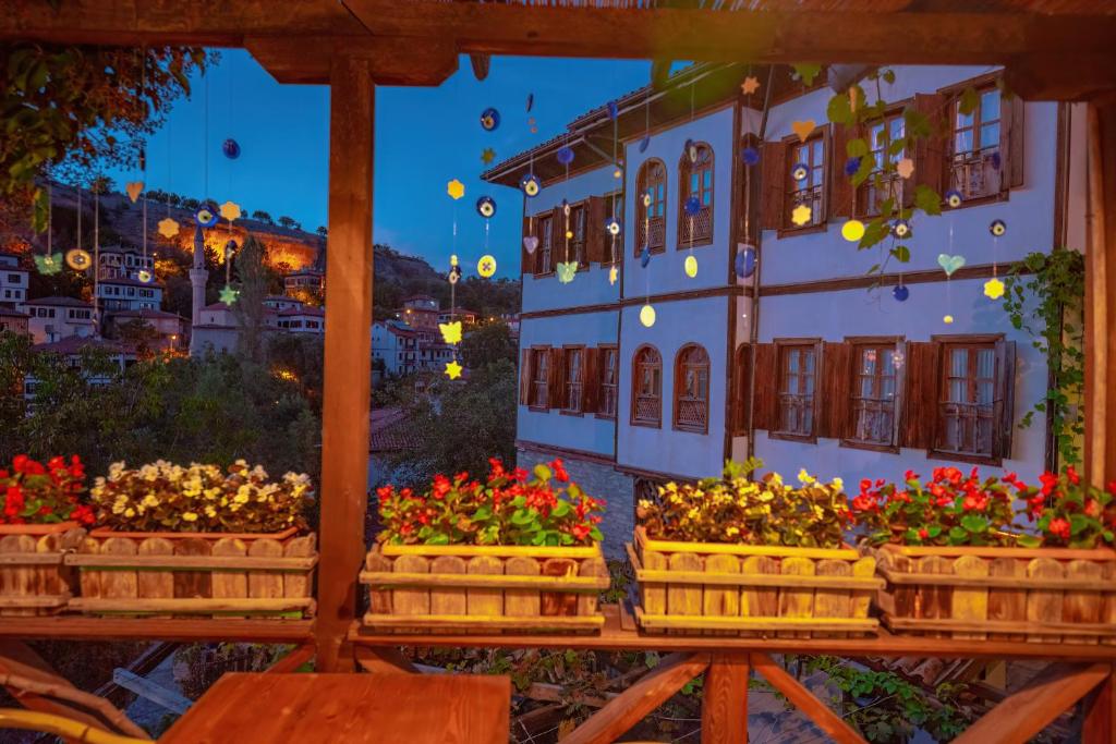 a bunch of flowers in boxes in front of a building at Cesmeli Konak Garden in Safranbolu