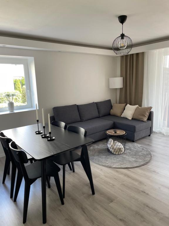 a living room with a couch and a table at Airport City Zürich in Opfikon