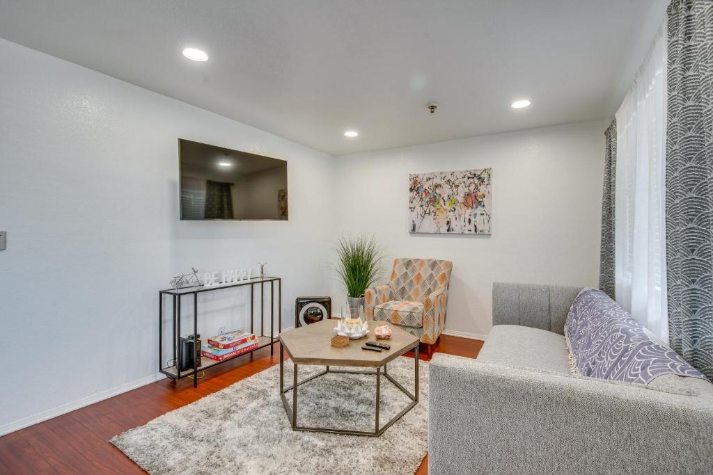 a living room with a couch and a table at Modern Hawthorne Apartment Near SoFi Stadium in Hawthorne