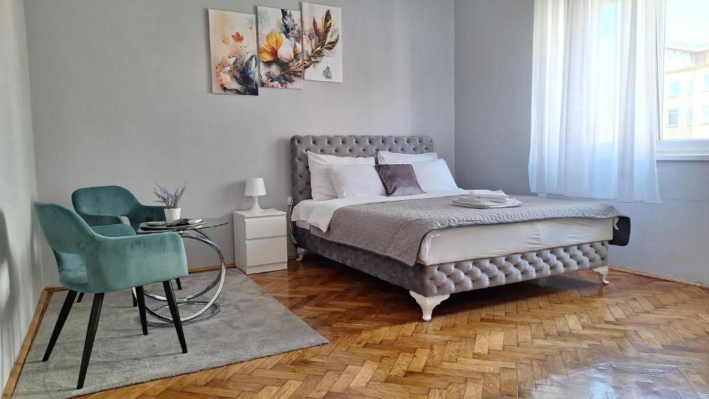a bedroom with a bed and a chair in it at Apartment Nataly in Vračar (historical)