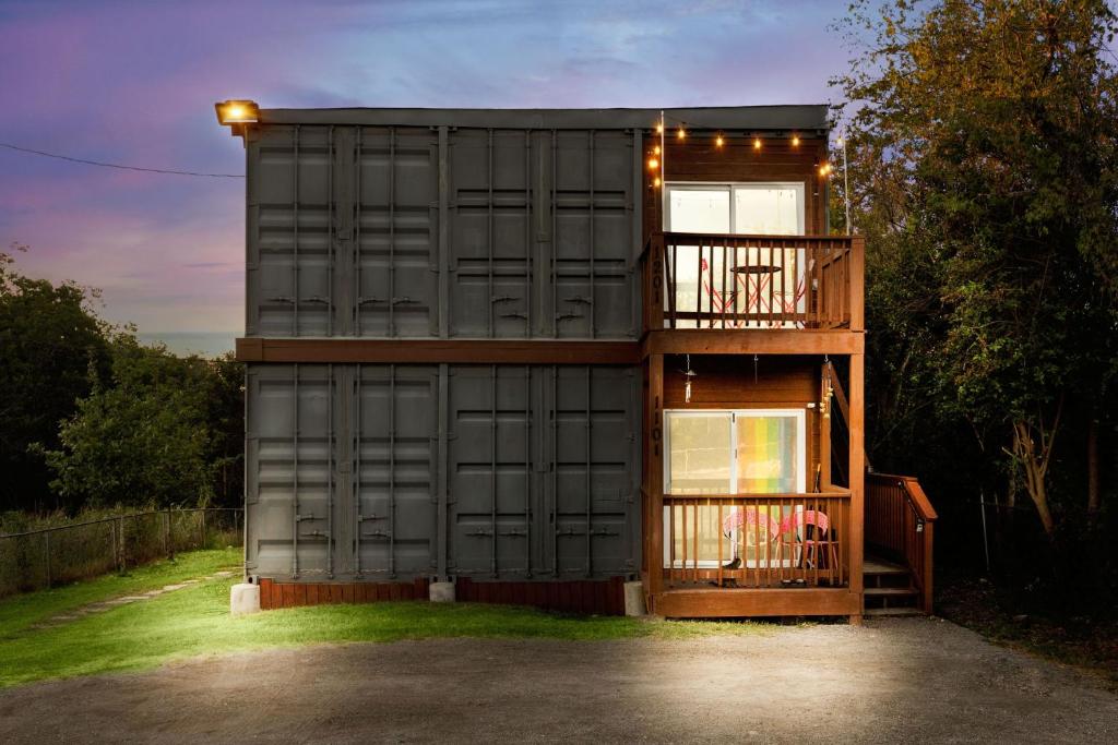 a small house with a balcony and a deck at Divine Cargo in San Antonio