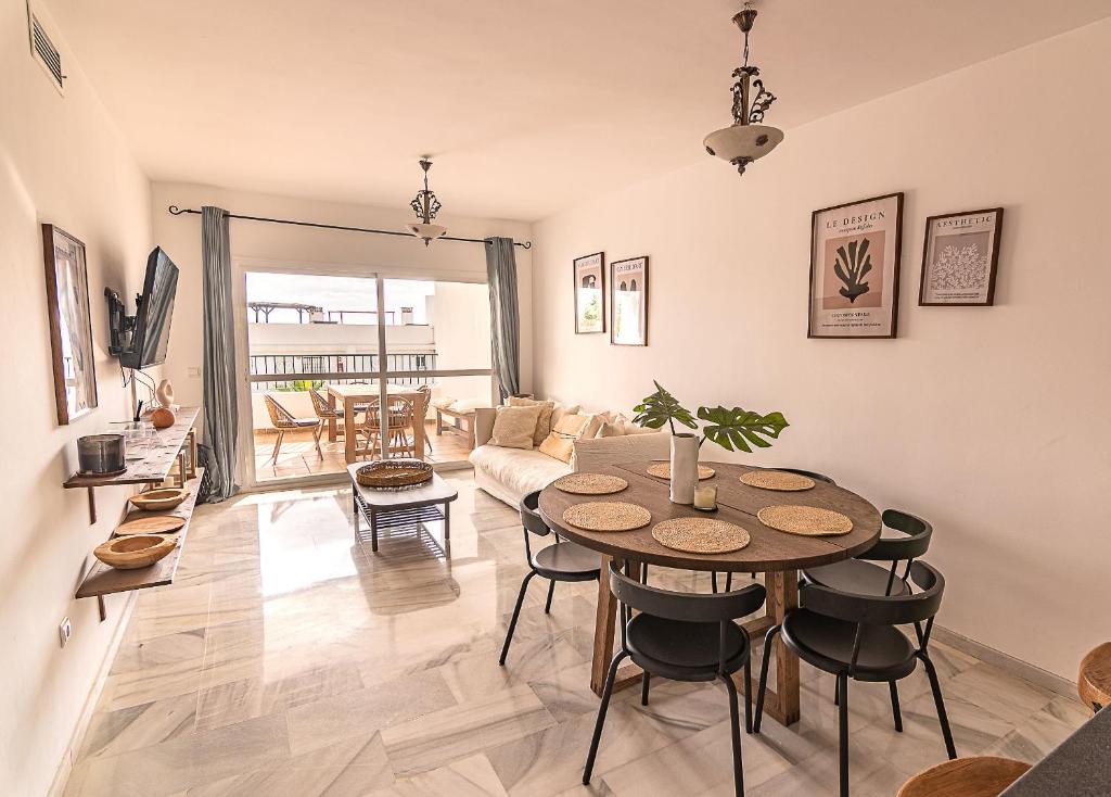 a living room with a table and chairs at Luxury apartment in Miraflores in La Cala de Mijas
