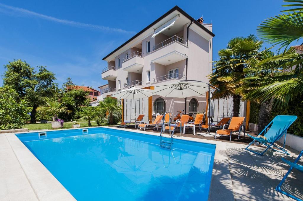 a villa with a swimming pool in front of a house at Villa Marea in Rovinj