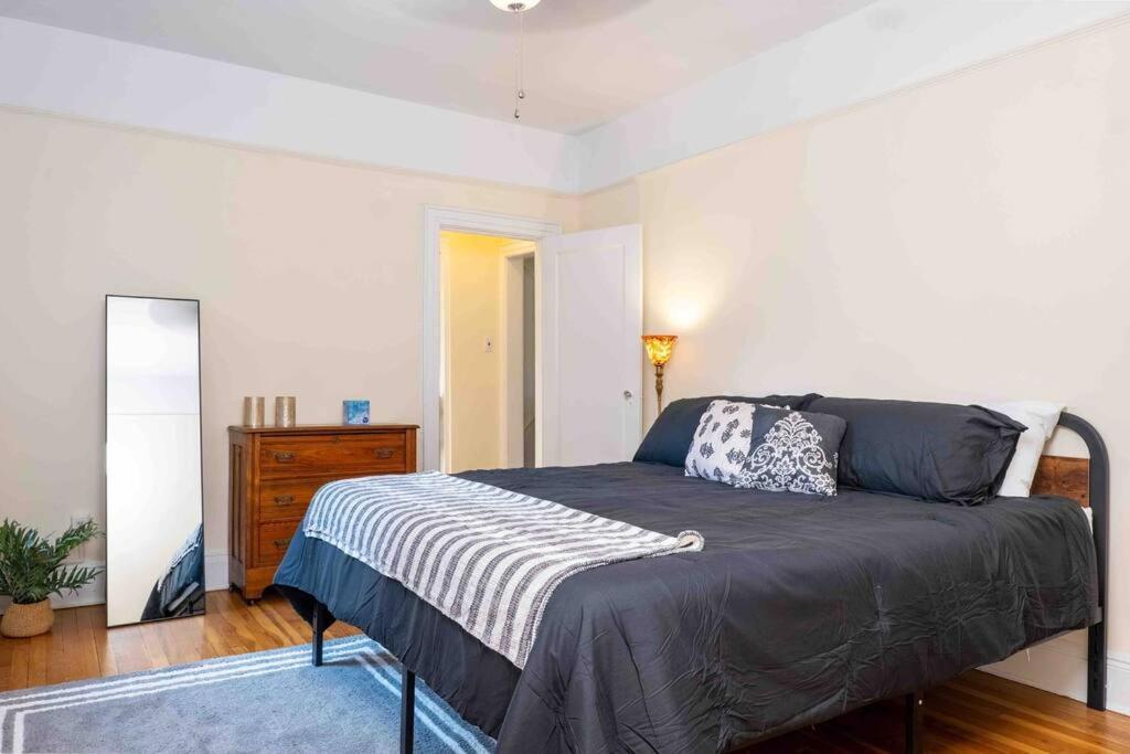 a bedroom with a bed and a dresser at Spacious Oasis - Hoboken California King Bed! in Hoboken