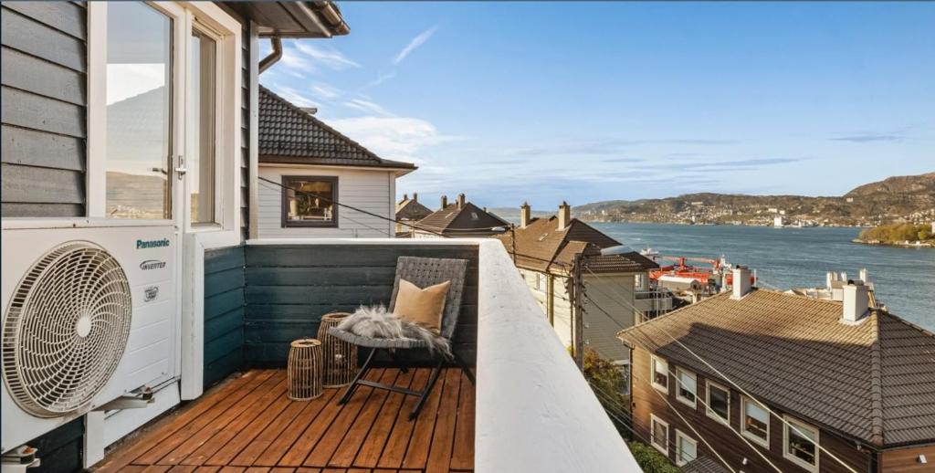 a balcony of a house with a view of the water at Beautiful apartment with amazing view in Bergen