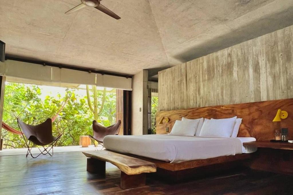 a bedroom with a large bed and two chairs at Casa Altanera in Recado