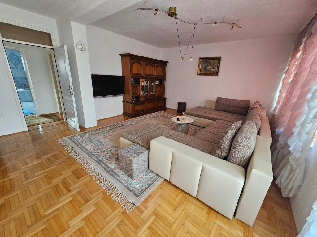 a living room with a couch and a table at Stan Sana-Centar in Sanski most