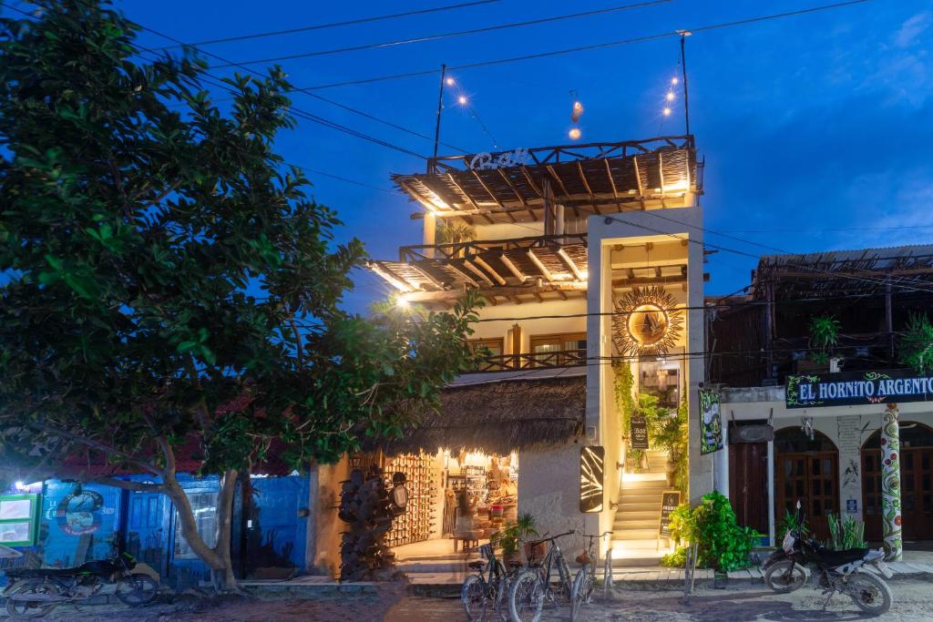 a building with lights on it at night at Hotel Arena in Holbox Island