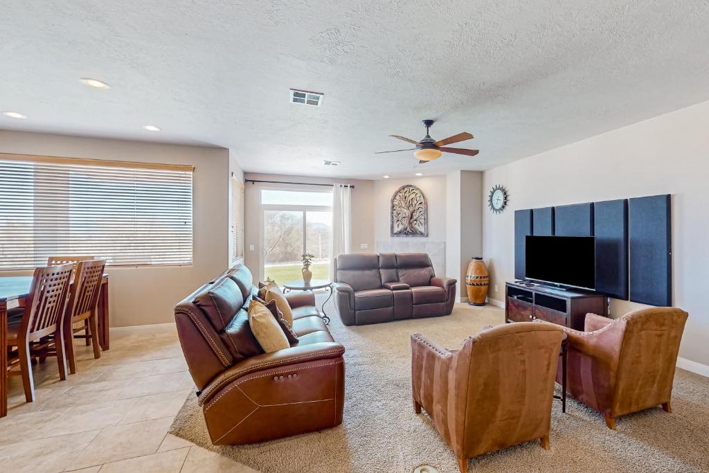 a living room with furniture and a flat screen tv at Las Palmas Leisure in St. George