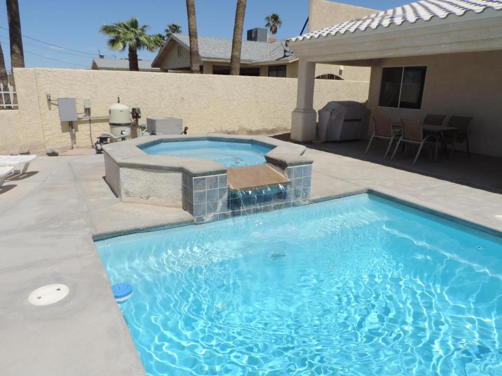 a swimming pool in a yard with a patio at Alibi-Step to open desert in Lake Havasu City