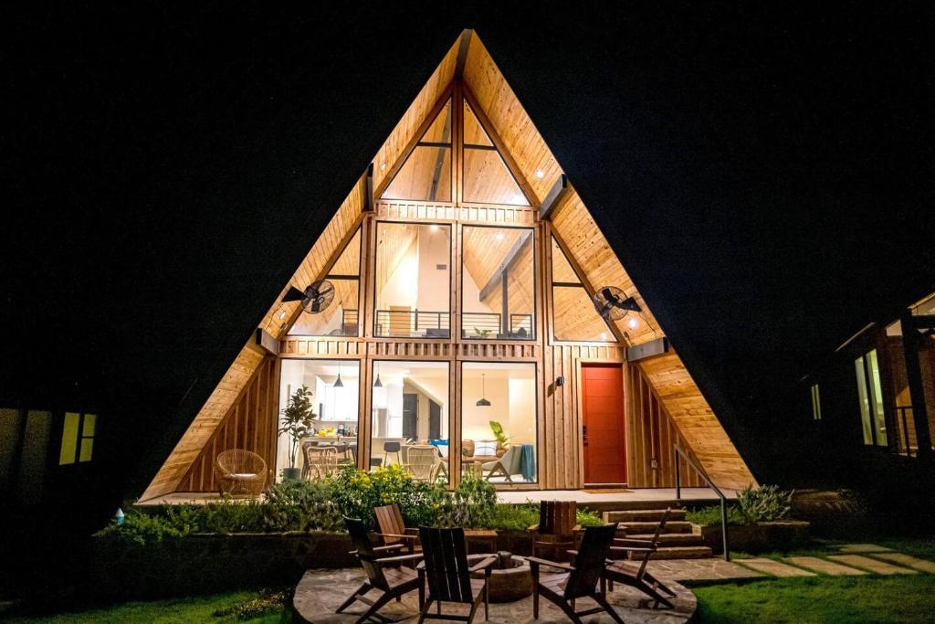 a house with a triangular roof with a lot of windows at Gruene Daze Chalet - Stylish Aframe - Escape the Ordinary in New Braunfels
