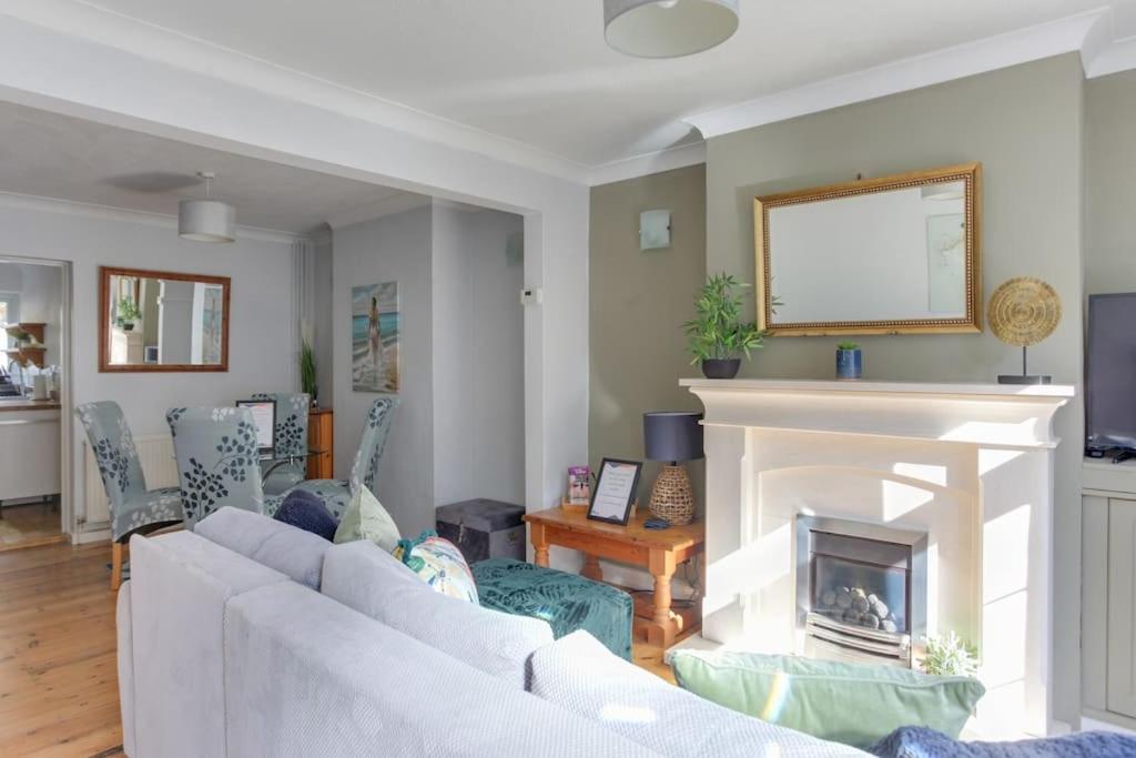 a living room with a couch and a fireplace at Roman Cottage Chelmsford in Chelmsford