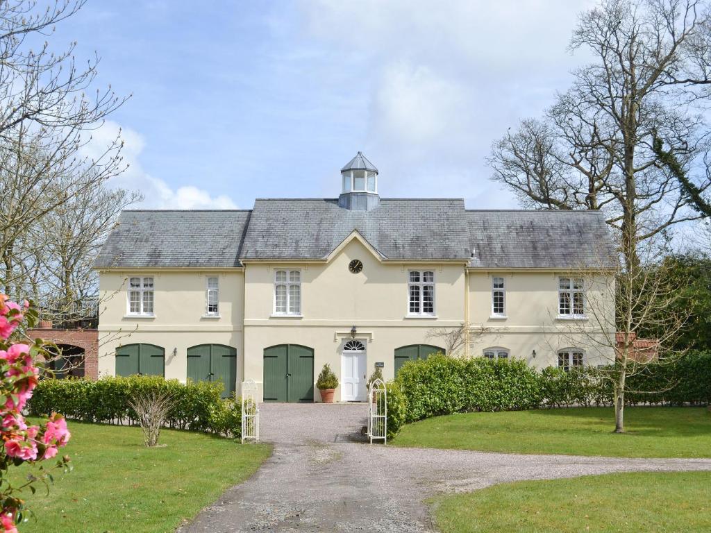 a large white house with green doors and a driveway at Cutcliffe Chambers - Hppr in Bideford