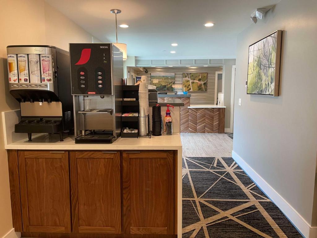 a kitchen with a counter with a coffee maker at Best Western Town House Lodge in Modesto