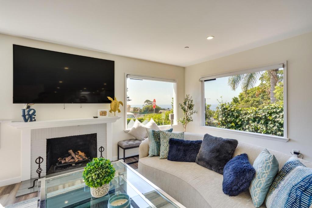 a living room with a couch and a fireplace at Laguna Beach Escape with Hot Tub and Ocean Views! in Laguna Beach