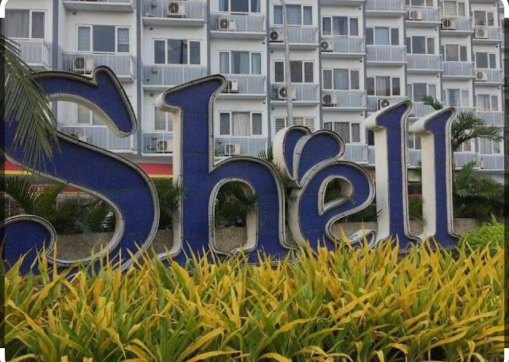 a large sign in front of a large building at Shell Residences near Mall Of Asia in Manila