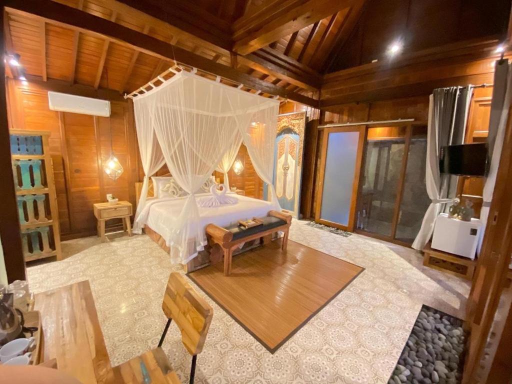 Postel nebo postele na pokoji v ubytování Barong Bali Resort Ubud
