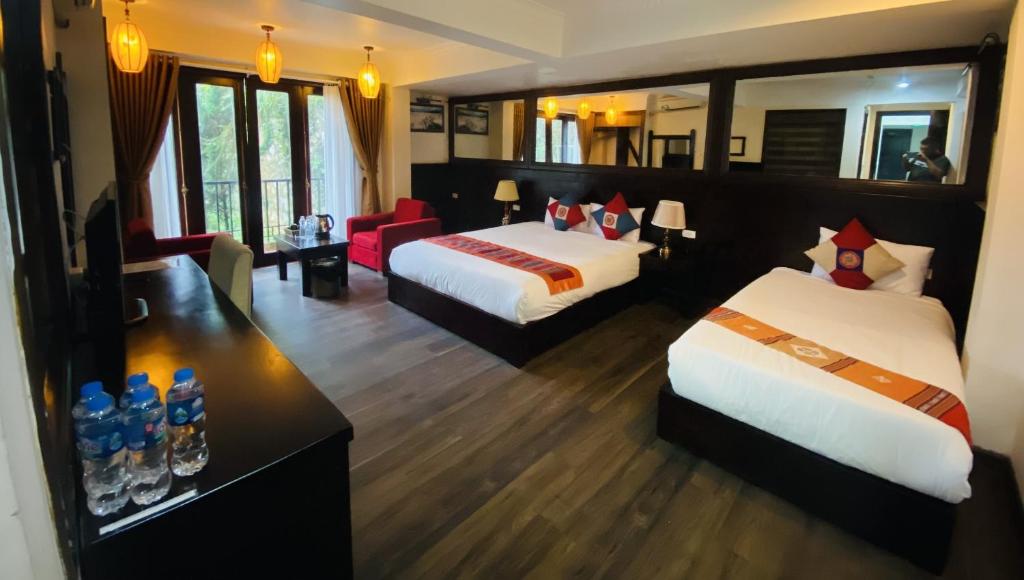 Postel nebo postele na pokoji v ubytování Sapa Elite Hotel