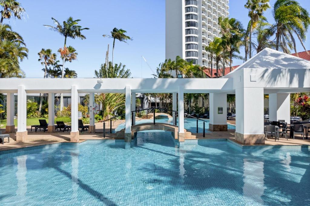 a swimming pool with a pavilion and a building at Crowne Plaza Surfers Paradise, an IHG Hotel in Gold Coast