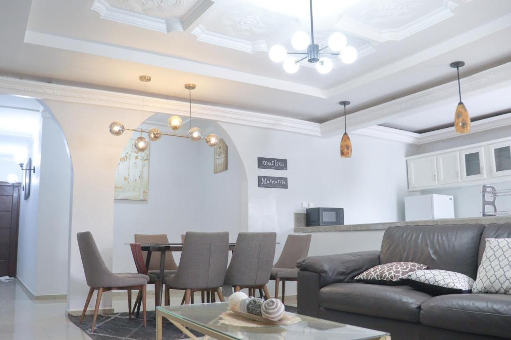 a living room with a couch and a table at MARIBART RESIDENCE - Électricité inclus, Forage in Yaoundé