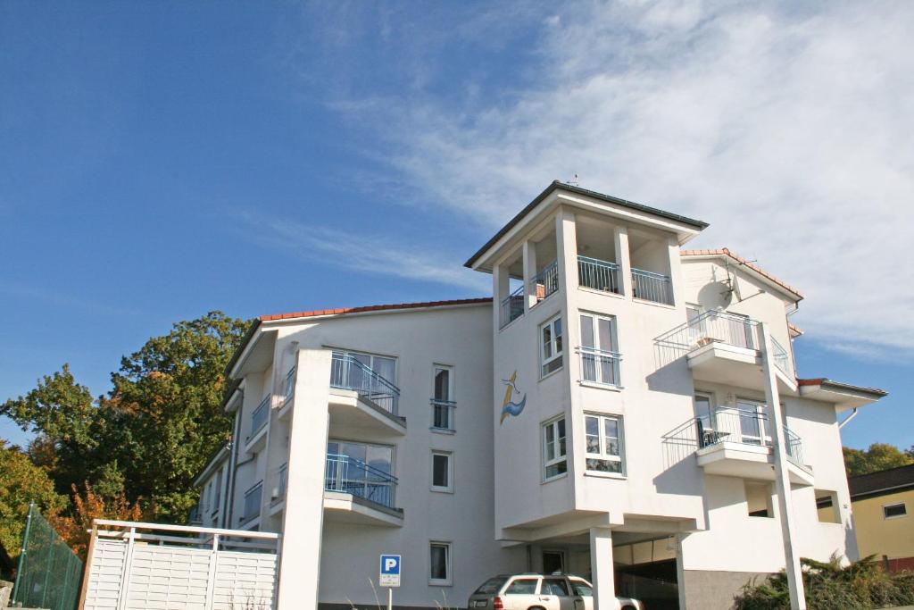 a white building with a car parked in front of it at Residenz Binz - FeWo 16 in Binz