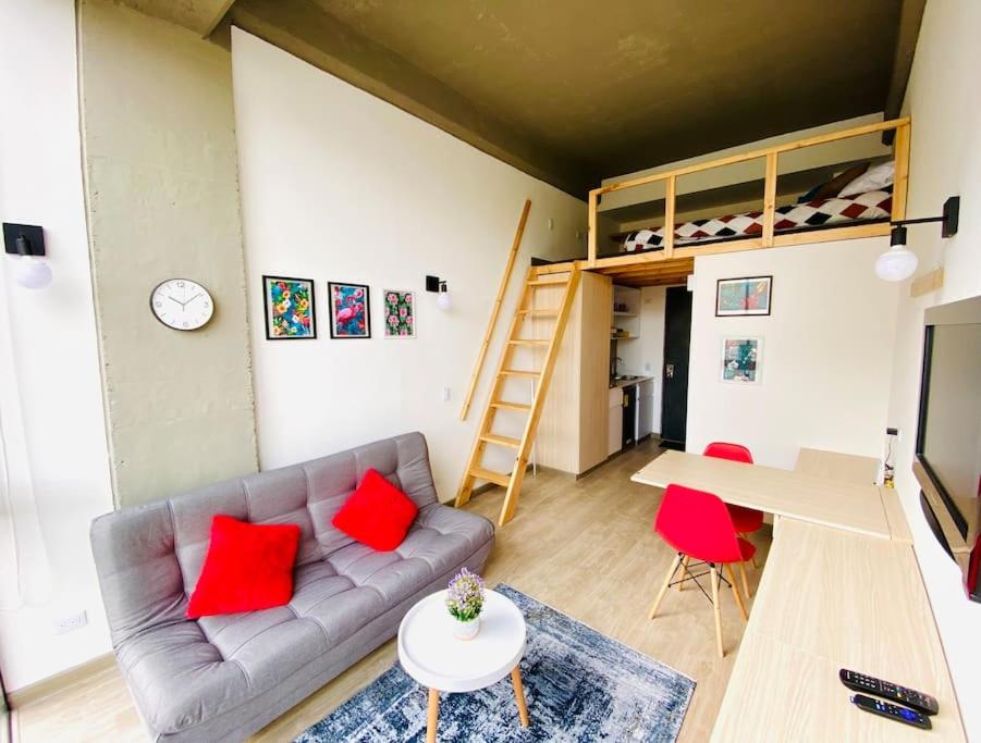 a living room with a couch and a bunk bed at Loft en chapinero, Bogota in Bogotá