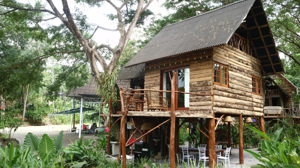 a tree house with a black roof at Uma Villa Manado in Manado