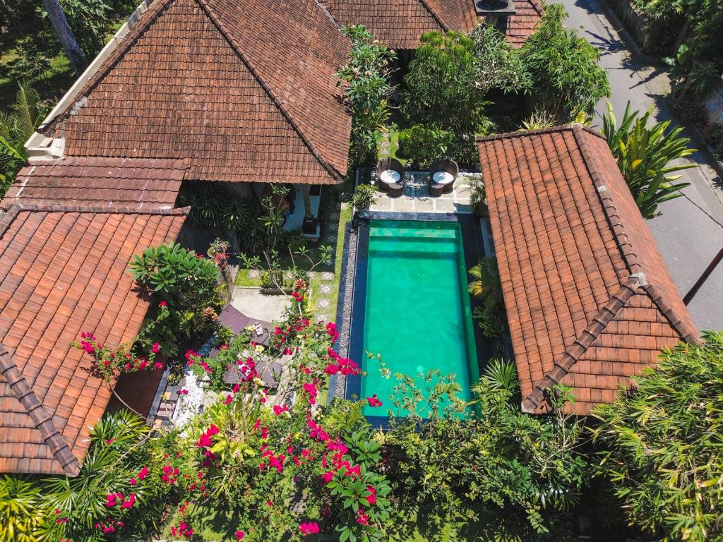 an overhead view of a swimming pool between two roofs at Dewata ubud in Ubud