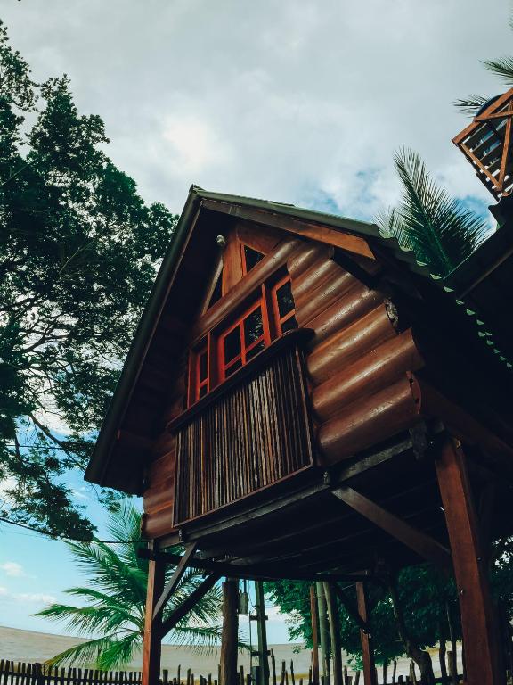 a tree house with a balcony on it at Chalé da Árvore in Belém