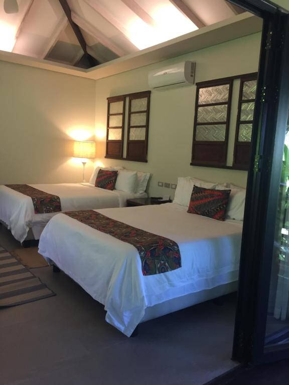 Postel nebo postele na pokoji v ubytování Kaimana Resort Siargao